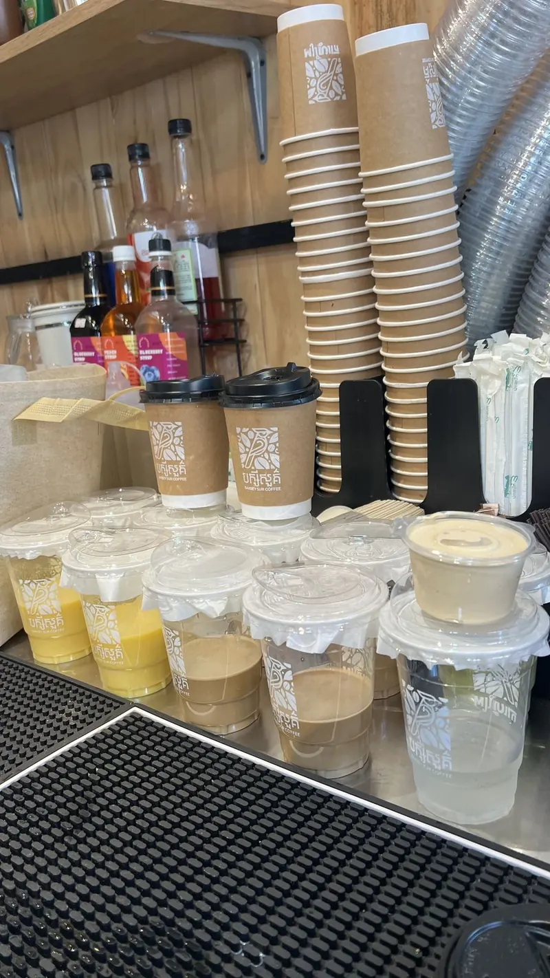 A line of sealed takeaway drinks on the bar